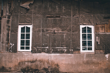 Fototapeta na wymiar Two windows on an old derelict building