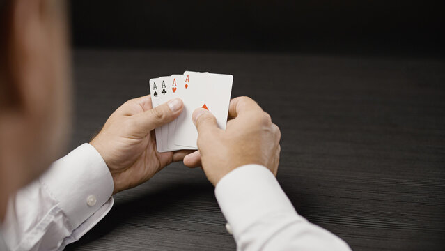 Poker player holding four of a kind with aces, good combination, winning