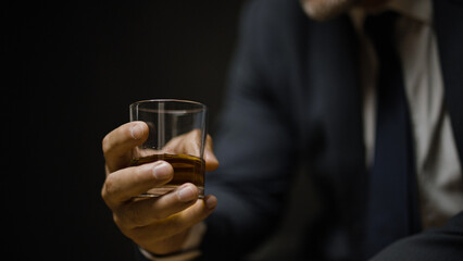 Male expert enjoying taste and aroma of strong alcoholic beverage, degustation