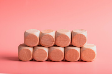 blank wooden dice for inserting text.on pink background
