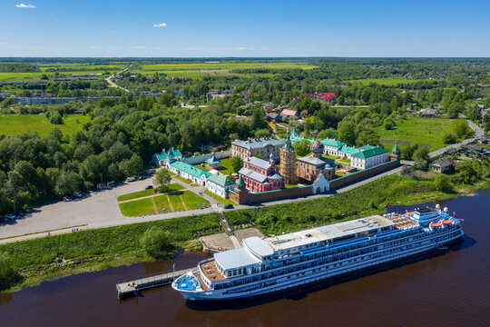Aerial view of Nikolsky monastery and cruise ship on Volkhov river on sunny day. Staraya Ladoga, Leningrad Oblast, Russia.