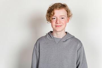 redheaded teen boy with grey shirt on studio