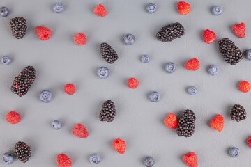 summer berries are laid out on the table in a chaotic manner