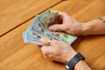 Businessman hands counting cash american dollars banknotes