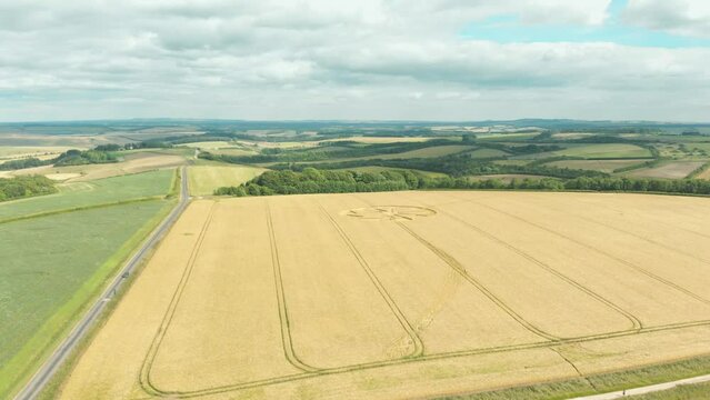 Aerial drone shot of ufo crop circle design in corn field, Wiltshire, UK