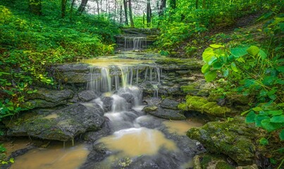 Long exposure waterfall flowing over rocky surface in Cherokee Park, Louisville, Kentucky, USA