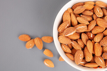Almonds in a bowl are on the table. High quality photo