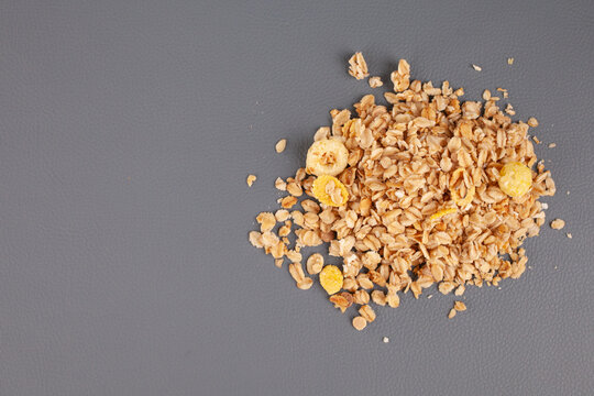 Granola Spread Out On A Gray Background . High Quality Photo