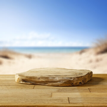 Wooden table with a podium and free space for your products. Summer holiday day and seascape.