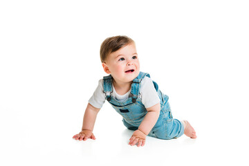 Cheerful baby boy toddler on white studio background