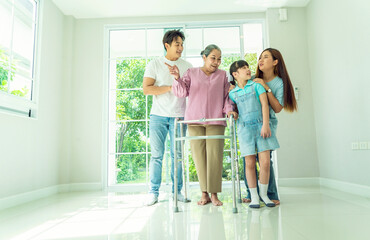 Grandma takes Walker to move into her new home with her family, her son and daughter-in-law and granddaughter are all happy to buy a new home. Home loan and family relationship concept.
 