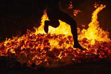 Summer solstice celebration jumping into the fire. Burning flames