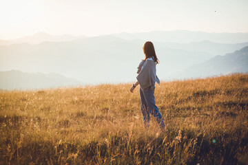 Pretty Teen Girl in Beautiful Mountain Landscape at Morning Sunrise