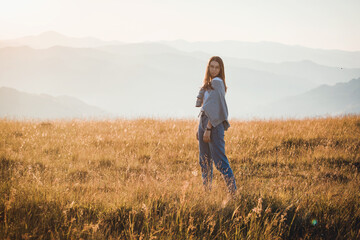 Naklejka na ściany i meble Happy Teen Girl in Golden Mountain Sunrise Landscape 