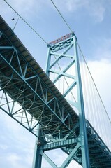 Vertical low angle shot of the Ambassador suspension bridge under the blue sky