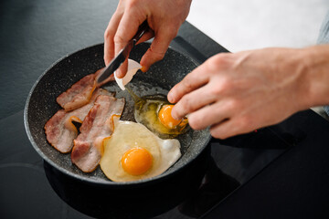 Young man making lunch while spending time at home