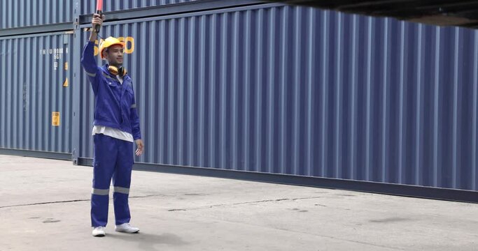 Inventory management and logistics, Asian man warehouse freight forwarder supervises the loading of containers.