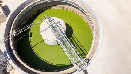 Aerial view of the tanks of a sewage and water treatment plant enabling the discharge and re-use of waste water. It's a sustainable water recycling with treatment plant.