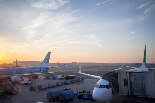 AMSTERDAM - NETHERLANDS, NOVEMBER 15, 2018: KLM Dutch airlines planes taxxing while a Transavia plane is bording in Amsterdam Schiphol Airport, the hub of KLM carrier