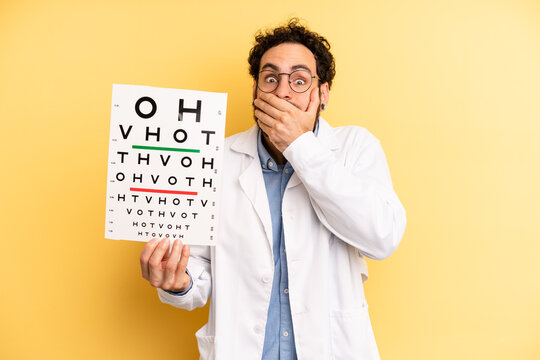 young man covering mouth with hands with a shocked. optical vision test concept