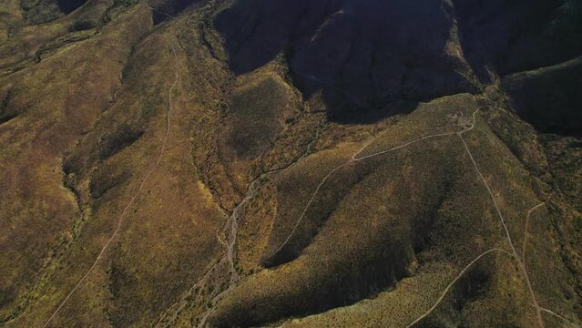 Transmountain Road Franklin Mountains El Paso Texas. Aerial Drone View Camera Panning Up From Desert Landscape Hills to Show Large Texas Border Mountain Range.