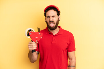 young man feeling disgusted and irritated and tongue out. company employee concept