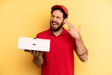 young man looking unhappy and stressed, suicide gesture making gun sign. pizza delivery concept