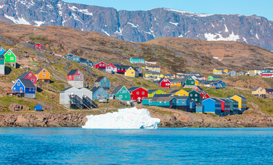 Night time in the northern hemisphere concept - Picturesque village on coast of Greenland - Colorful houses in Tasiilaq, East Greenland