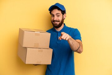 young man pointing at camera choosing you. company employee concept