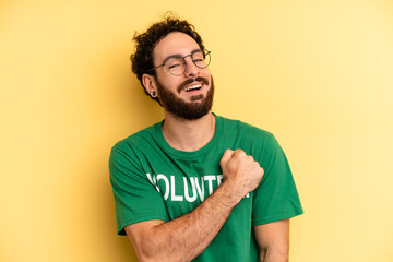 young man feeling happy and facing a challenge or celebrating. volunteer concept