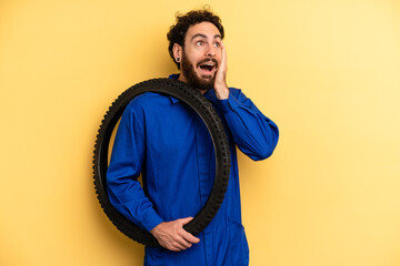 young man feeling happy, excited and surprised. bike mechanic concept