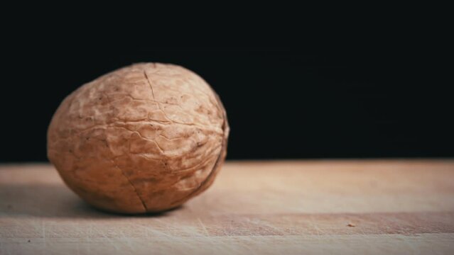 Hammer cannot break the walnut on a black background. toughie. Nuts are good for the brain. Heap of walnuts close-up.