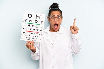 hispanic woman feeling like a happy and excited genius after realizing an idea. optical vision test...