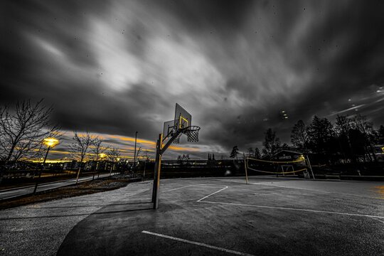 Breathtaking view of a basketball and volleyball courts against dark cloudy sky background