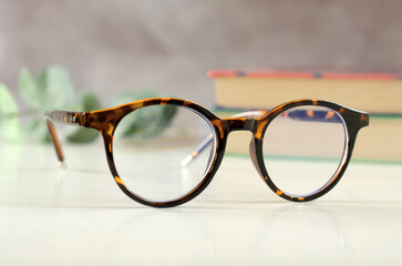 Fototapeta na wymiar Stylish eyeglasses in leopard color on the desk.