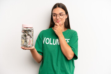 pretty woman smiling with a happy, confident expression with hand on chin. volunteer and donation...