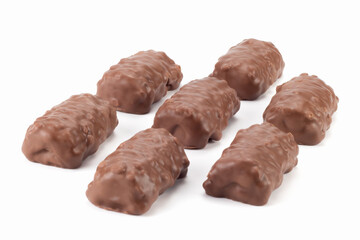 Arranged crispy bits of chocolate bars. Chocolate bars with peanuts and caramel. Close up view.