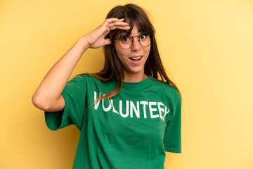 pretty woman looking happy, astonished and surprised. volunteer and donation concept