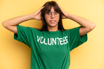 pretty woman feeling stressed, anxious or scared, with hands on head. volunteer and donation concept