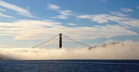 Breathtaking view from the bay of Golden Gate Bridge in San Francisco, California partially in mist