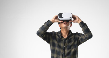 Asian handsome man with using virtual reality headset or VR glass isolate on gray background