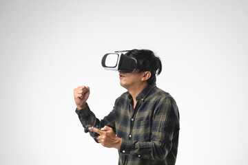 Asian handsome man with using virtual reality headset or VR glass  with joystick isolate on gray background