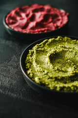 Beetroot hummus and spinach hummus. Vegan recipes, plant-based dishes. Homemade healthy organic food. Vegetarian cuisine. Top view 