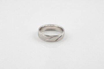 Closeup of a silver ring with simple patterns isolated on a white background