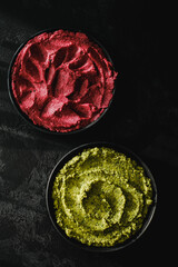Beetroot hummus and spinach hummus. Vegan recipes, plant-based dishes. Homemade healthy organic food. Vegetarian cuisine. Top view 