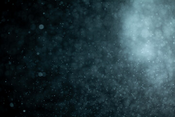 Glowing blue highlights. Wallpaper pattern. Blue sparkling spots. Dust or fog on a black background.