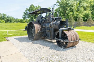 Vintage steamroller near a park on a sunny day