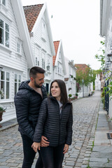 Fototapeta premium Couple in love looking at each other on a tourist street in Stavanger, Norway.