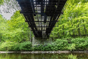 Low angle shot of a beautiful bridge constructed above the water in Lancaster, MA, USA