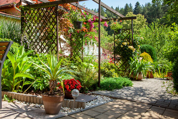 Beatiful backyard garden with flowers in full bloom in sunny day in summer.
